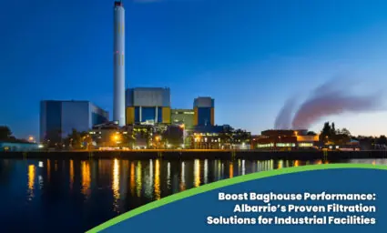 Industrial waste management facility at dusk with tall smokestack and modern baghouse system – Albarrie filtration solutions for compliance and efficiency.