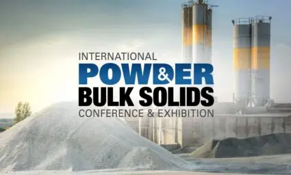 International Powder & Bulk Solids Conference & Exhibition logo over an industrial facility with storage silos and aggregate piles.