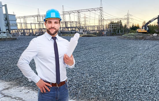 Albarrie engineer standing in front of containment with plan