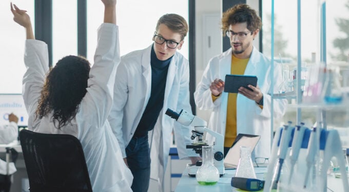 Group of scientists in lab celebrating success