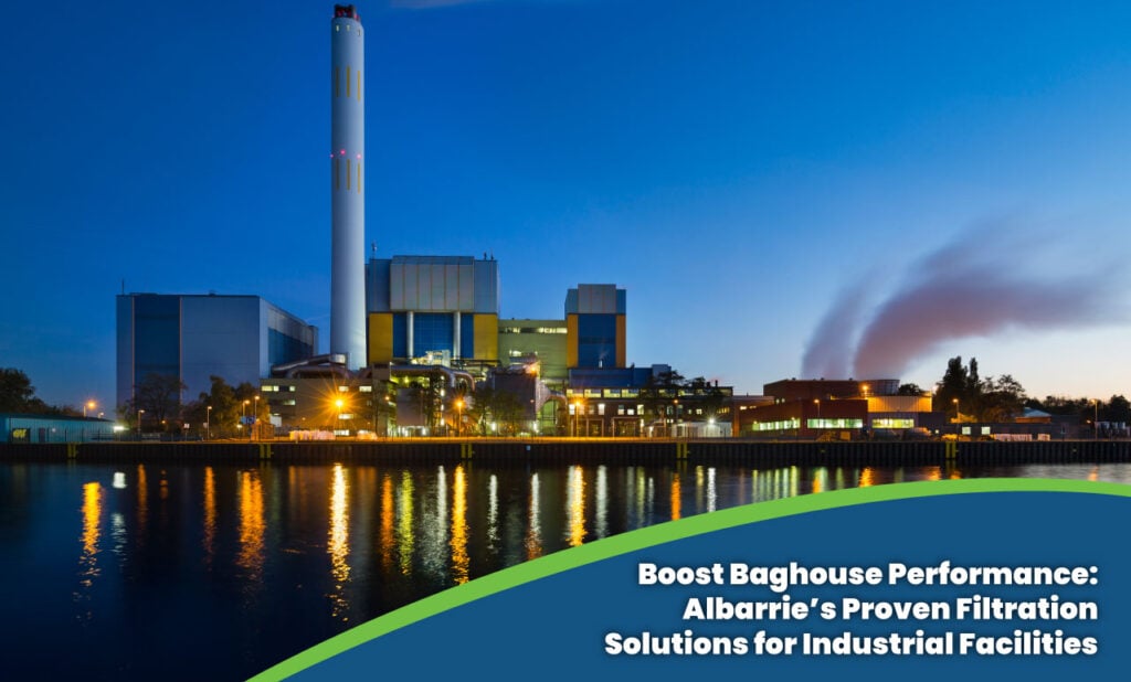 Industrial waste management facility at dusk with tall smokestack and modern baghouse system – Albarrie filtration solutions for compliance and efficiency.