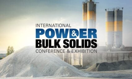 International Powder & Bulk Solids Conference & Exhibition logo over an industrial facility with storage silos and aggregate piles.